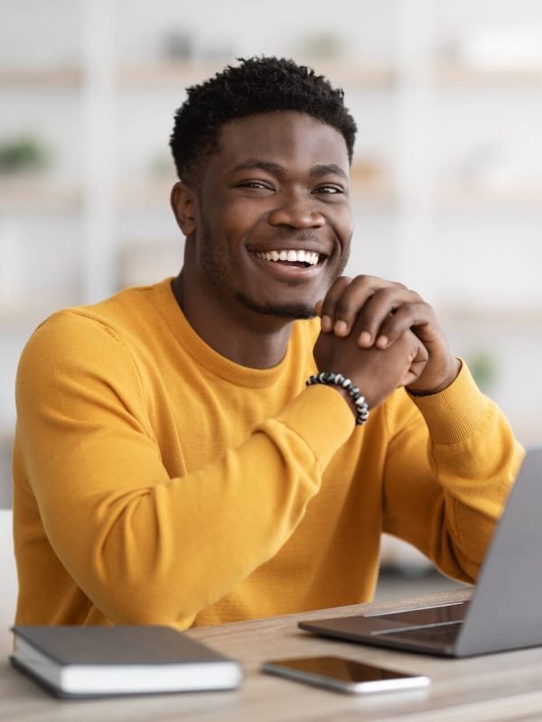 black-man-freelancer-sitting-at-workdesk-at-home-2022-12-16-08-26-37-utc-e1683773703351.jpg