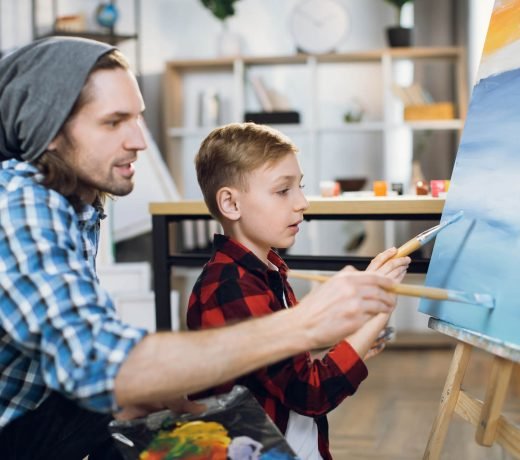 teacher-and-schoolboy-painting-with-brushes-on-can-2022-04-27-03-29-49-utc.jpg